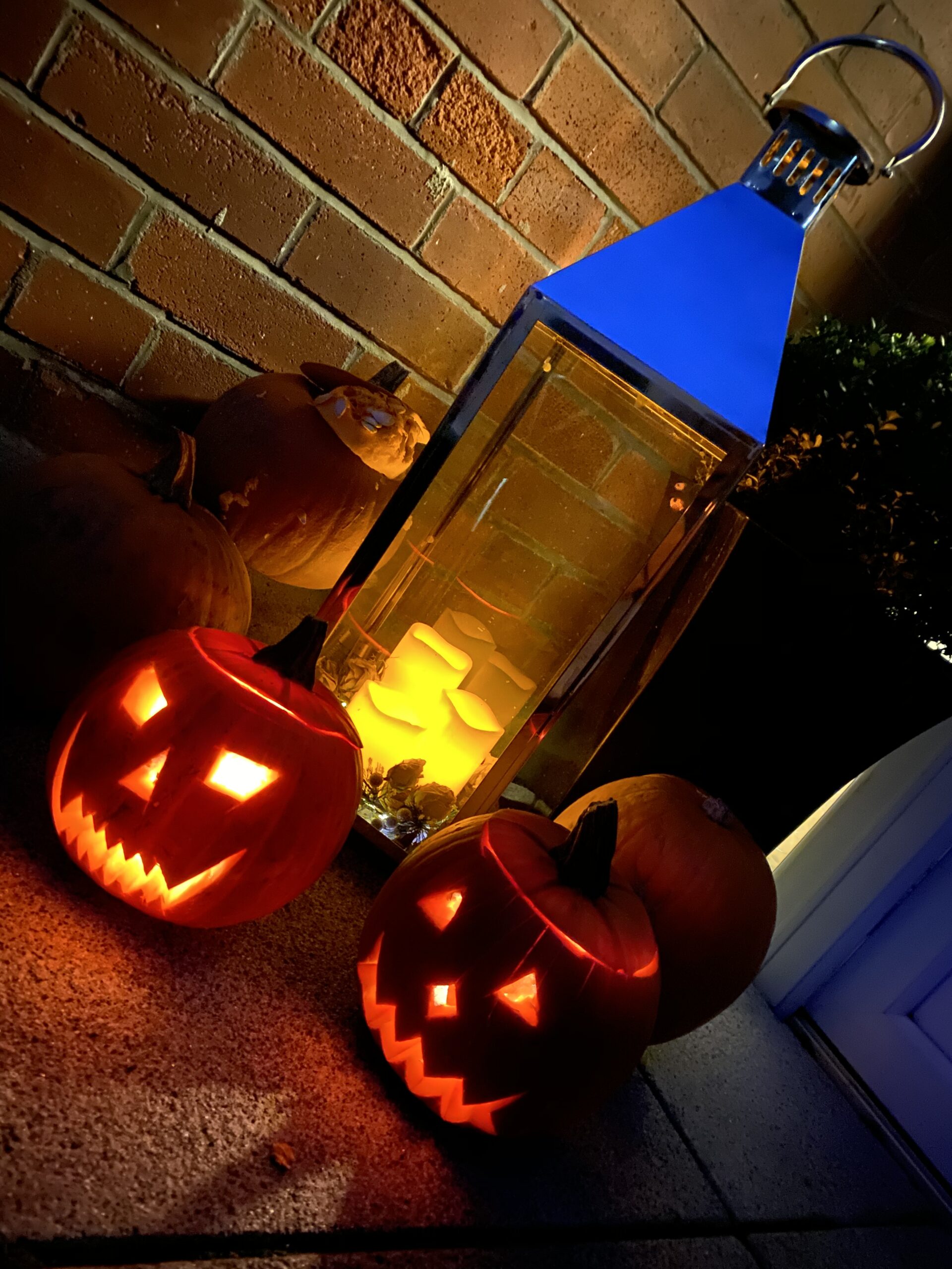 This is a Halloween image showing lit pumpkins and candles