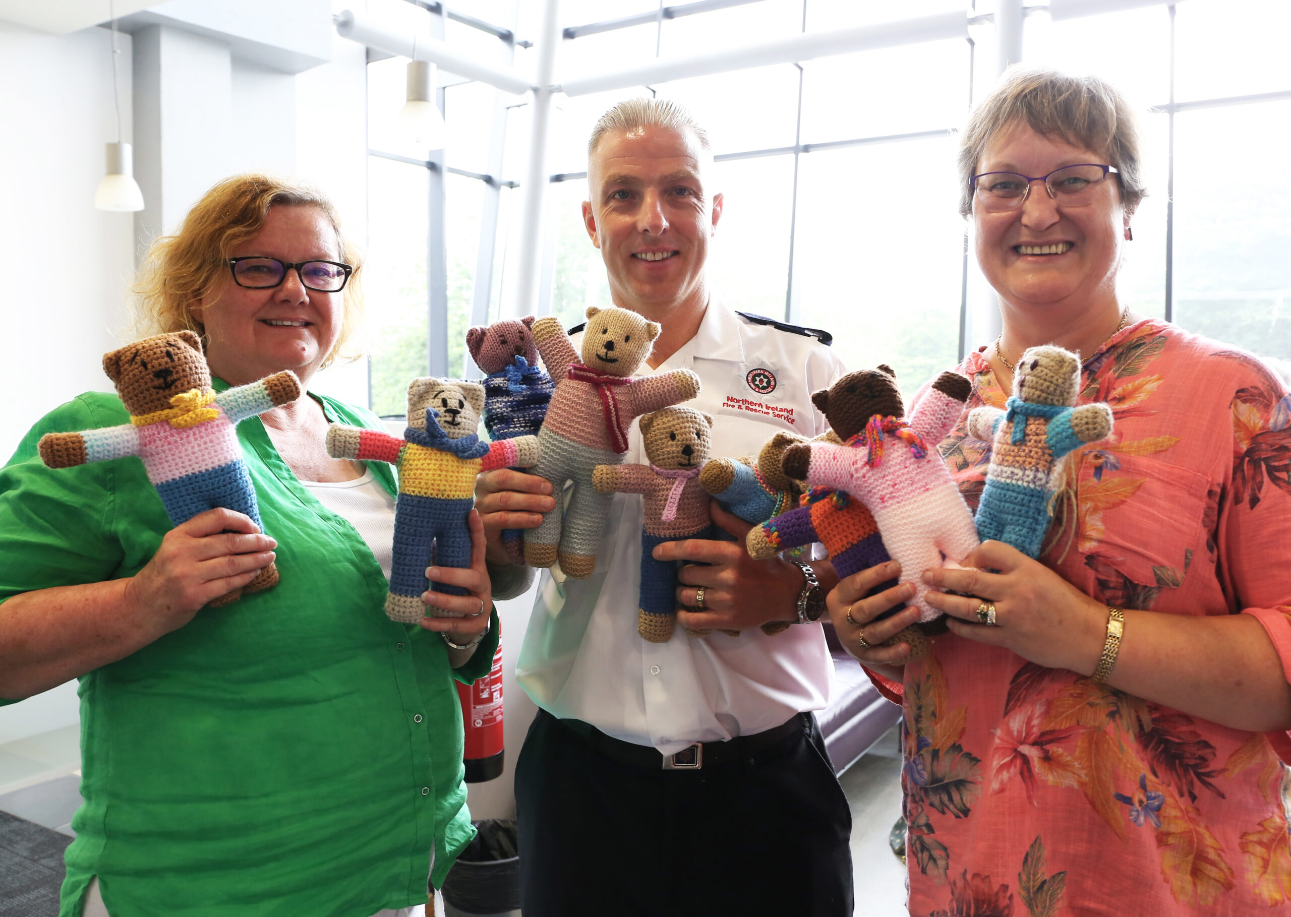 Watch Commander Bryan McCaul with members of Lisburn ‘Knit and Natter’ who contributed to the Trauma Teddies project.