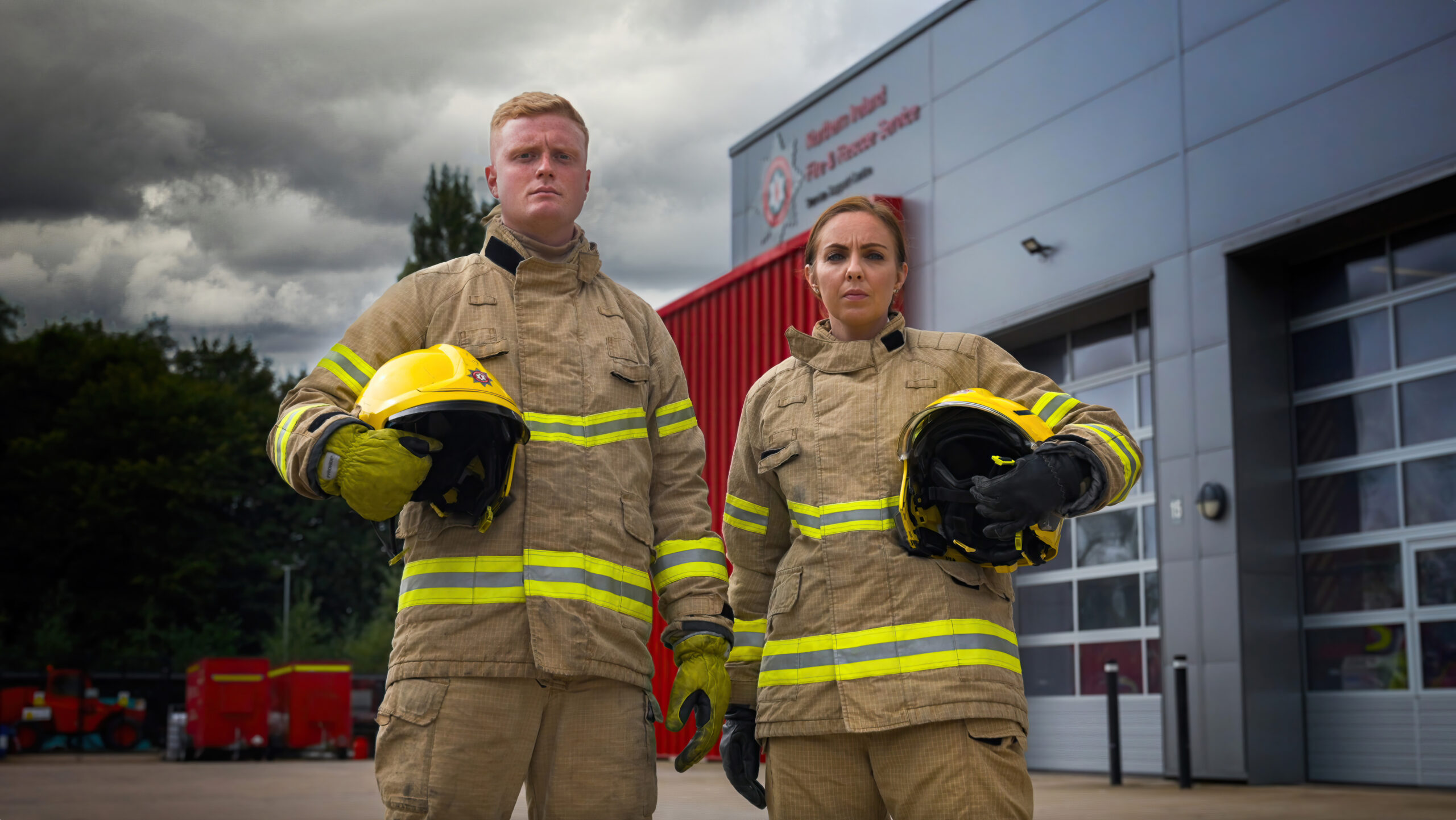 Male and Female Firefighters outside Fire Service Building.