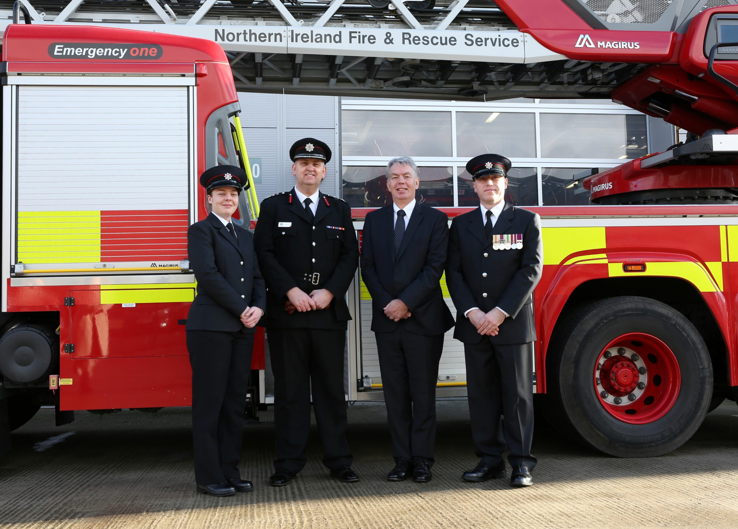 Standing left to right Firefighter Hannah Tucker; NIFRS Chief Fire & Rescue Officer, Aidan Jennings; NIFRS Chairperson, Jay Colville; and Firefighter Alastair Bowler with a Fire Appliance in the background